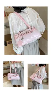 Pink stylish shoulder bag with star charm and buckle details, worn by model in detail view.