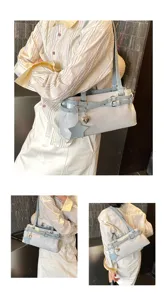 Stylish light blue white shoulder bag detail showing stylish underarm design with charms.