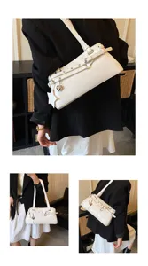 White shoulder bag with buckle straps and star charm detail, stylish underarm bag for daily use.