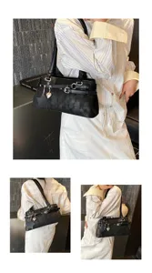 Detail view of black shoulder bag with metal buckle, star charm, and elegant underarm design.
