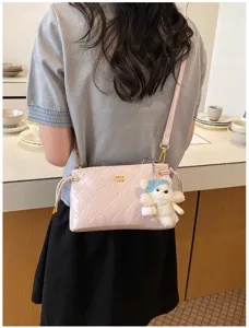 Pink quilted underarm shoulder bag for women, chic commuting crossbody bag with cute bear charm.