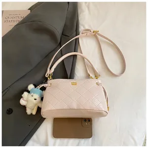 Detailed view of women quilted shoulder bag with chic bear pendant and premium chain strap.