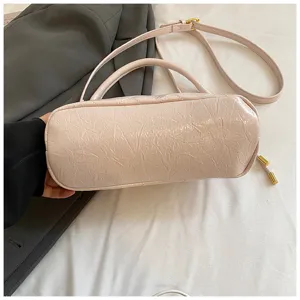 Pink quilted cylindrical shoulder bag detail, stylish PU leather handbag with adjustable strap.