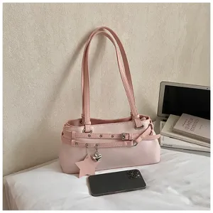 Chic pink shoulder bag detail shot featuring double straps, buckled belts, and cute star heart charms.