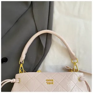 Detail view of a stylish pink quilted underarm handbag with gold hardware for women commuter.