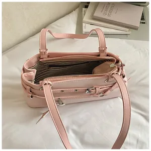 Pink stylish shoulder bag for women, large capacity daily commuting tote bag with buckle details.