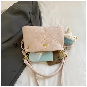 Detail view of pink quilted shoulder bag featuring premium texture and metallic hardware.