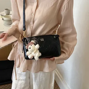 Stylish quilted underarm bag for women, chic patent leather shoulder handbag with chain.