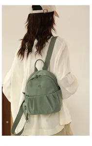 Casual nylon backpack detail view, light green small daypack for women travel and daily use.
