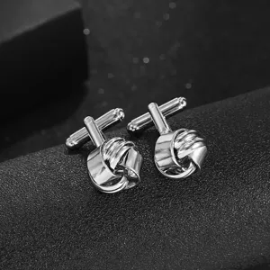 Gros plan détaillé de boutons de manchette noués en métal argenté pour homme, chic et élégant.