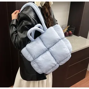 Detailed view of the light blue puffed quilted tote bag, soft padded bags for women
