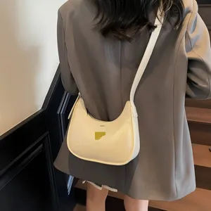 Chic minimalist crescent shoulder bag for women, versatile PU leather underarm handbag.