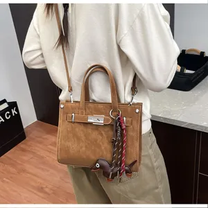 Brown PU leather shoulder bag for women, stylish crossbody bag with cute dog pendant and metal lock.