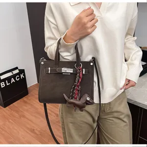 Stylish women shoulder bag detailed view, elegant brown tote design with cute puppy charm.