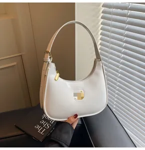 White patent leather hobo shoulder bag detailed view, elegant minimalist baguette handbag design.