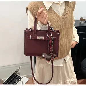 Chic burgundy small square bag detail, featuring stylish design and charm.