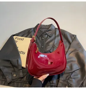 Burgundy patent leather shoulder bag, chic hobo baguette bag with gold hardware for women.