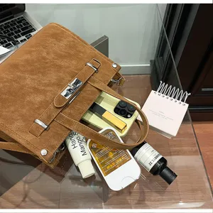 Detailed view of the stylish brown leather small square shoulder bag with metal lock detail.