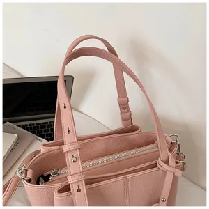 Pink leather tote bag for women, stylish shoulder handbag with multi-compartments.