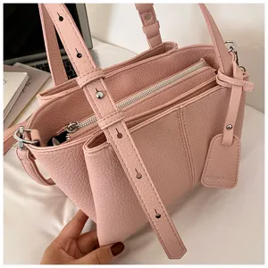 Pink PU leather multi-compartment tote shoulder handbag with zipper closure and top handle.
