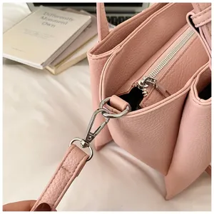 Pink lychee pattern women's shoulder bag, stylish tote bag with metallic zipper and durable strap.