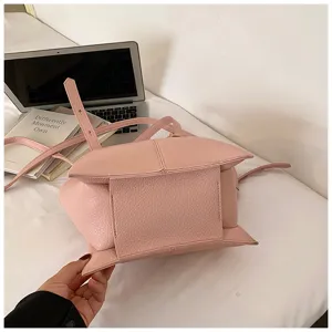 Pink leather shoulder handbag detail view, elegant women commuter tote bag structure.