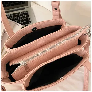 Detailed top view showing the interior design of women's pink multi-compartment leather tote bag.