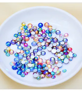 Close-up details of vibrant AB color flatback glass rhinestones for DIY nail art and crafts.