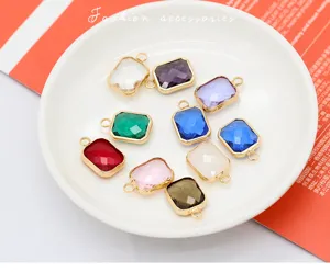 Close-up of colorful rectangular crystal charms with gold edges for DIY jewelry making.