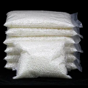 Detail view of bulk white flatback half round ABS craft pearls packed in clear bags for DIY.