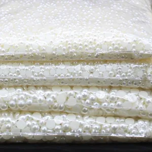 Close-up detail of bulk flatback white half pearls for DIY crafts and phone decoration.