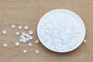 Detail shot of white flatback half pearls for DIY crafts, phone decoration and handmade accessories.