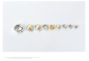 Close-up detail of various sizes of round claw glass rhinestones for DIY sewing projects.