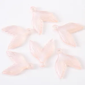 Close up detail of sparkling pink mermaid tail acrylic DIY jewelry pendants charms.