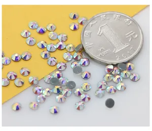 Flatback AB crystal rhinestones detail shot, sparkling iridescent DIY nail art gems with coin scale.