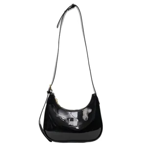 Black patent leather shoulder bag for women, chic hobo baguette handbag with adjustable strap.