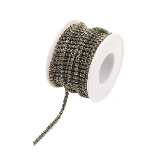Colorful rhinestone cup chain on spool for DIY phone case crafting and garment decoration.