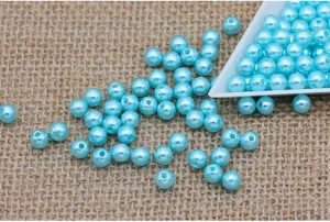 Detailed view of light blue ABS plastic imitation pearl beads, straight hole design for DIY.
