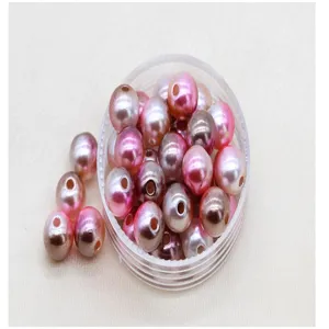 Vista dettagliata di perle ABS colorate con sfumatura per nail art, perle forate.