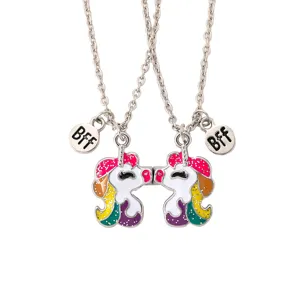 Close-up of magnetic unicorn BFF necklace detail, showing enamel metal finish and chain links.