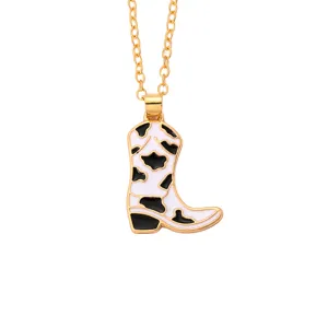 Gold-tone chain necklace featuring a cute enamel cow print cowboy boot pendant detail.