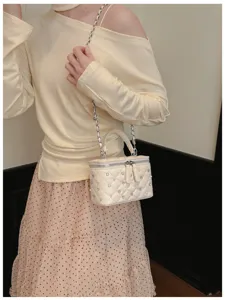 Detailed view of the chic quilted vanity shoulder bag featuring elegant studs and chain.