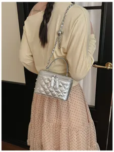 Detailed view of the stylish quilted box bag with chain strap, rhinestones, and pearls.