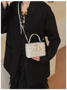 Silver quilted chain vanity cross-body bag featuring top handle and stylish studs for women