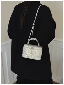 Chic quilted chain box crossbody bag for women, featuring stylish studs and a handy top handle.