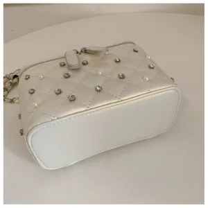 White quilted chain shoulder bag with pearls and rhinestones for women fashion detail view.