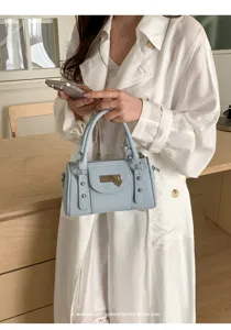 Light blue Boston bag detail shot, minimalist chic retro style daily commuting handbag