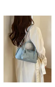 Light blue litchi pattern Boston shoulder bag, stylish women's crossbody handbag trend.