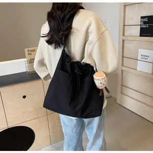 Large capacity casual canvas bucket bag for women, trendy commuting shoulder and crossbody bag.