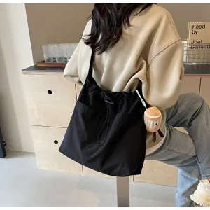 Large capacity casual canvas shoulder bag for women, stylish bucket bag for commute.